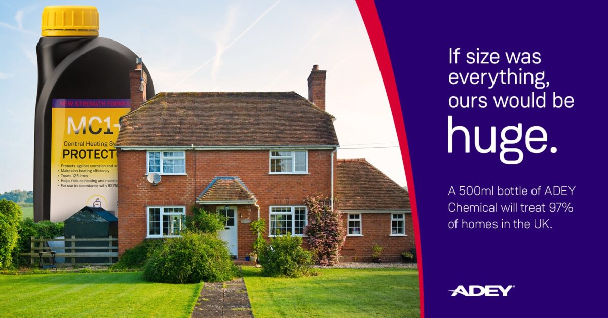 a brick house with a lawn and a large bottle of ADEY chemical product